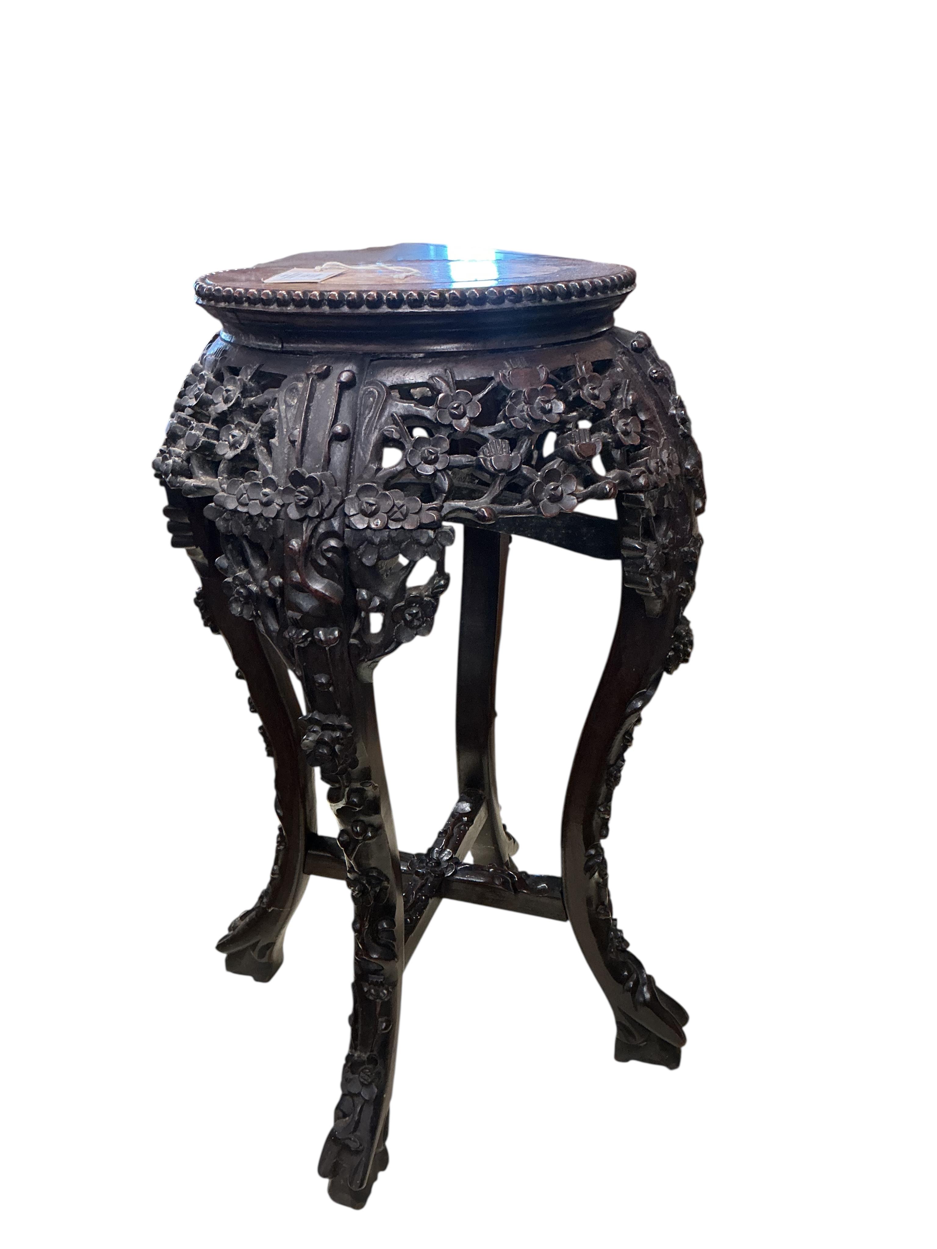 A Chinese carved padouk rouge marble topped jardiniere stand, height 60cm